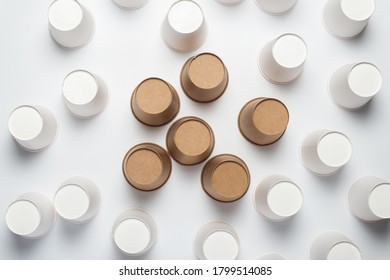 White And Brown Paper Cups Flipped Upside Down On A Light Background. Top View, Flat Lay