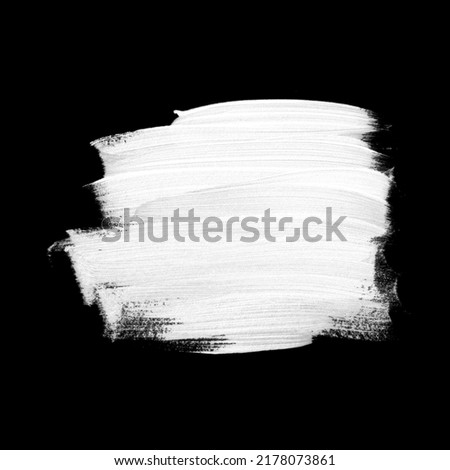 White brush stroke acrylic paint isolated on black background. Creative art design.