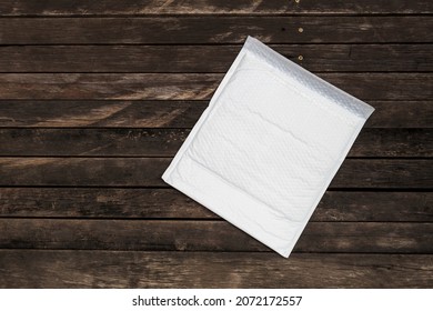 White Bubble Envelope With Space On Wood Background, Envelopes For Mailing