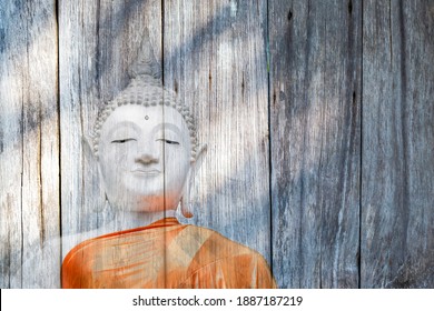White buddha immage on wood background