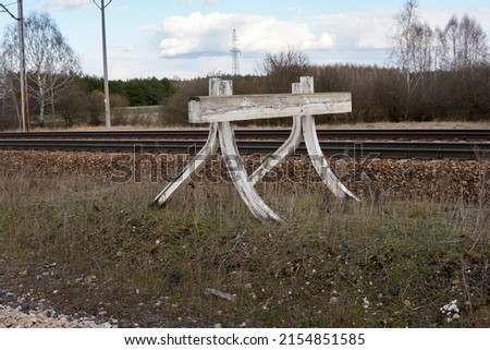 White buffer stop ending rail tracks concept for limit. Industrial landscape. The final line.                   