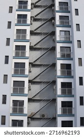 White building facade with external fire escape staircase