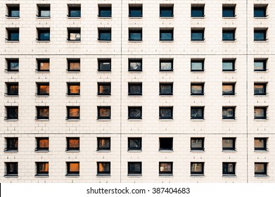 White building wall with square windows texture background. Vintage effect.
