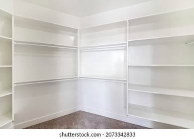 White Built In Wall Mount Shelving Unit In A Walk In Closet