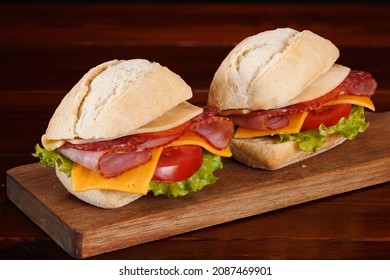 White Buns Sandwiches With Ham, Smoked Sausage, Cheese, Tomato And Green Salad.