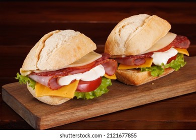 White Buns Sandwiches With Ham, Smoked Sausage, Cheese, Tomato And Mayonnaise Sauce.