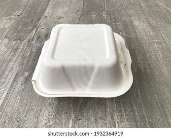 White Burger Box Against A Wooden Background