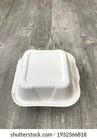 White Burger Box Against A Wooden Background