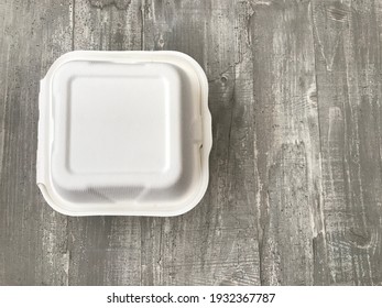 White Burger Box Against A Wooden Background