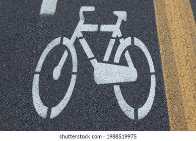 White Bycicle Sign On A Concrete Lane