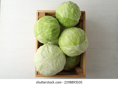White cabbage in crate on wooden table, top view - Shutterstock ID 2198893535