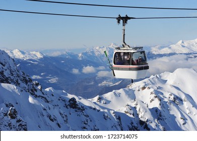 White cable car over ski valley Courchevel in European Alps in France. The cable car is typical to the best best resort in world Courchevel that is preferred both by beginner and professional skiers.  - Powered by Shutterstock