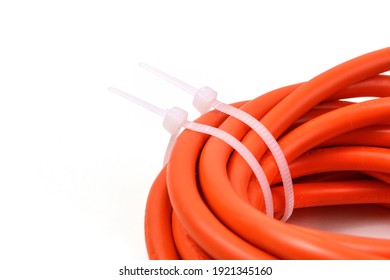 White cable ties on orange cable. Close up.