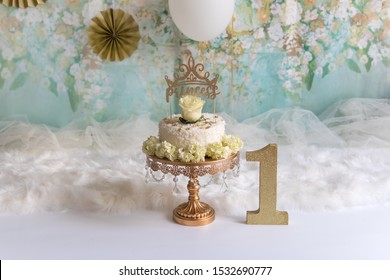 White cake for a girl on a gold stand. gold cake smash