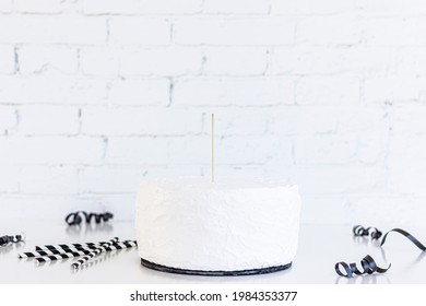 White Cake With Cake Topper Stick And Blank Stone Wall Background On Black Slice. Black Party Supplies And Paper Straws , Cake Topper Mockup