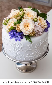White cake with whipped cream and close-up flowers