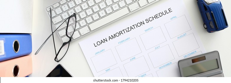 White calendar with loan amortization shedule sign closeup background. Right bank credit concept