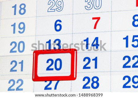 White calendar with a marked date twentieth
