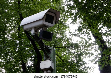 
White camera for tracking in the background of trees