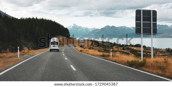 White camper van on the scenic route to Mt\
Cook in New Zealand, one of the world\'s most popular and\
picturesque road trip\
destination