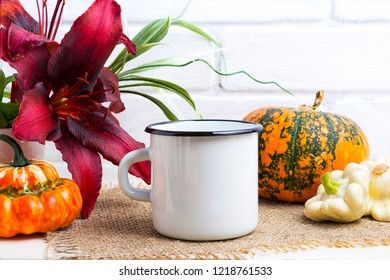 White Campfire Enamel Coffee Mug Mockup With Thanksgiving Fall Orange Pumpkin And Red Lily.  Empty Mug Mock Up For Design Promotion. 