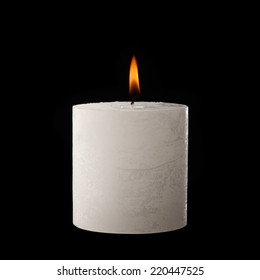 White Candle Lit On Black.