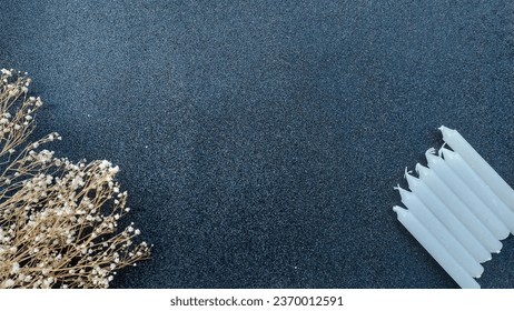 White candles on a black background with dried flowers. Copy space. - Shutterstock ID 2370012591