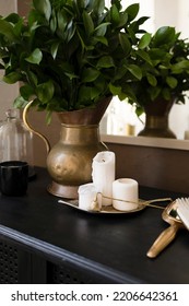 White Candles On A Black Chest Of Drawers