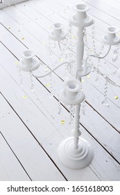 
White Candlestick Candelabra On Wood Floor With Confetti