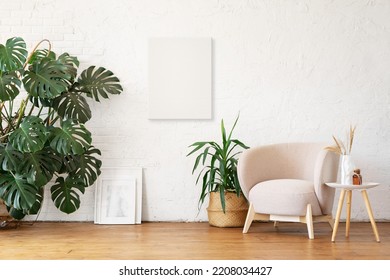 White canvas mockup for poster or lettering. A cozy modern beige armchair against the background of a white empty wall. Interior mockup with copy space. - Shutterstock ID 2208034427