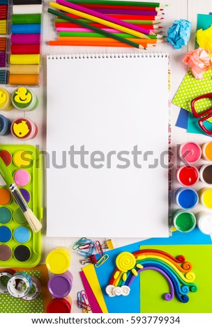 White canvas on a drawing table with school and office supplies