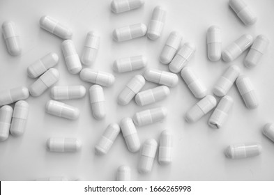 
white capsule pills on a white table