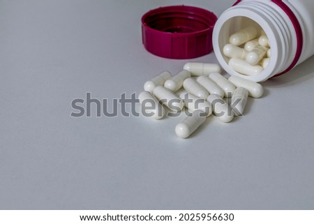 white capsules of manipulated remedy