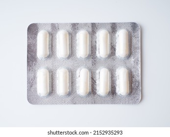 White Capsules Or Pills In A Grey Blister Pack. Close-up.