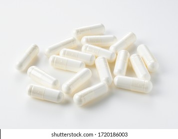 White capsules placed on a white background