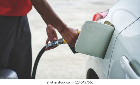 White Car Being Filled Gasoline Fuel By Man Attendant At Gas Station Service. Car Fuelling Petrol At Station In Sunny Day