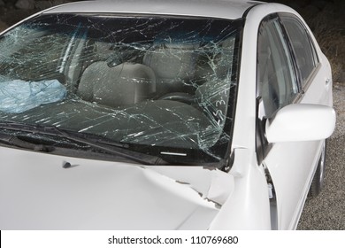 White car with broken windshield