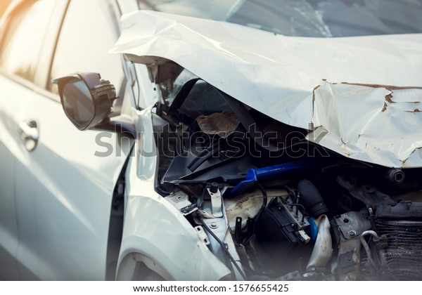 White car\
crash accident on the road. Sheet metal damage to cars. Broken\
passenger car close-up. Accident, car\
repair.