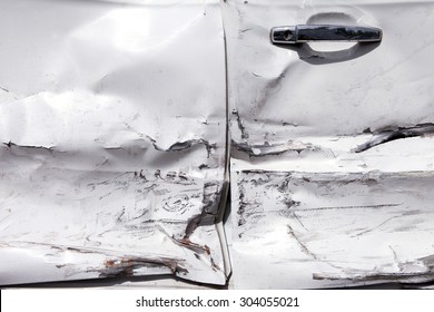 White car door with damage due to accident 