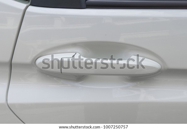 White car door handle close\
up.
