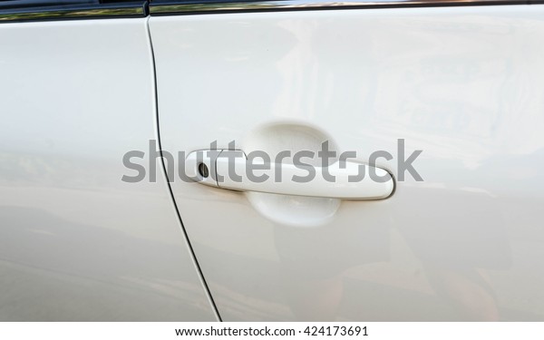 white car\
door and white handle focus for background - can use to display or\
montage on your product or car wash\
website