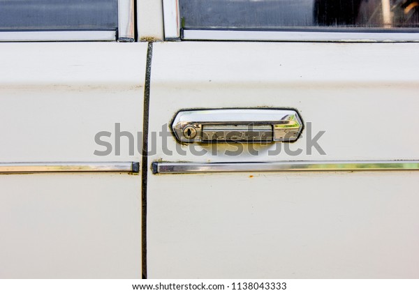 White car\
doors with a silver panel and door\
handle.