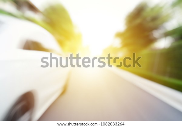 white car\
forward on asphalt road to goal with natural side view of fast\
motion background, advertise idea\
concept