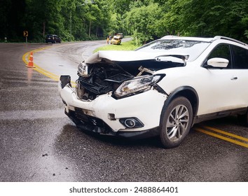 A white car had an accident on a curved road.