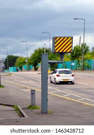 White Car On Road Passing Speed Camera Downtown Leith In Edinburgh City, Scotland. New Traffic Calming Measures. Uk. July 2019