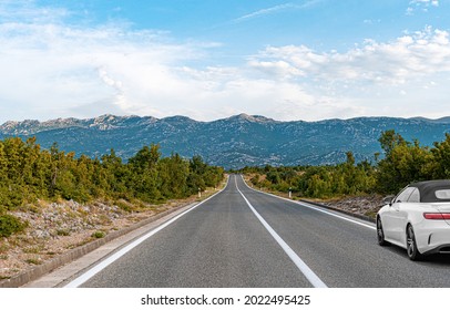 White Car On A Scenic Road. Car On The Road Surrounded By A Magnificent Natural Landscape.