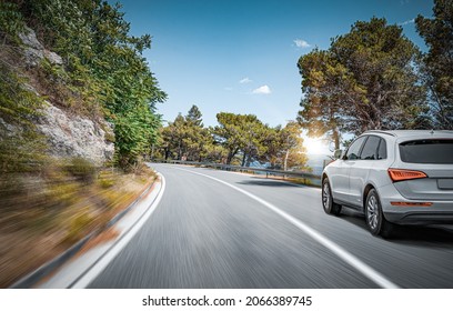 White car on a scenic road. Car on the road surrounded by a magnificent natural landscape. - Shutterstock ID 2066389745