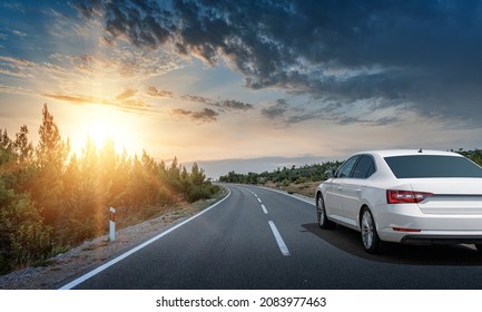 White Car On A Scenic Road. Car On The Road Surrounded By A Magnificent Natural Landscape.