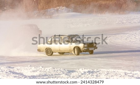 White car on slippery road on ice, selective focus, tinted image, sun flare.