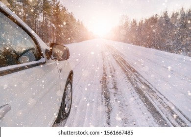 White Car On A Winter Road Through A Snow Covered Forest. 